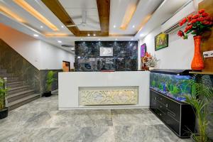 a large fish tank in a room with stairs at Hotel Gloory Suites Near Delhi Airport in New Delhi