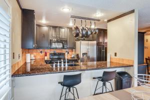 a kitchen with stainless steel appliances and black cabinets at Modesto Vacation Home 6 Mi to Downtown! in Modesto
