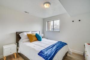 a bedroom with a bed with a blue blanket on it at Salt Lake County Home Near 4 Major Ski Resorts! in Midvale