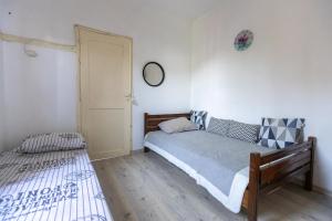 a bedroom with two beds and a mirror on the wall at SOFIA'S HOUSE No 2 in LESVOS in Apidias Lakos