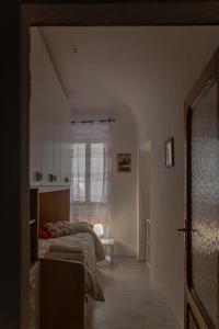 a bedroom with two beds and a window at All'ombra del Campanile in Volterra