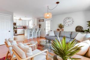 a living room with a couch and a kitchen at Quiet Mountain-View Home Near Conway and Hiking in Fryeburg