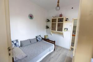 a bedroom with a bed in a white room at SOFIA'S HOUSE No 2 in LESVOS in Apidias Lakos