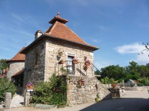 un piccolo edificio in pietra con una croce sopra di Chambres d'hôte Mas de Bouzou a Grèzes
