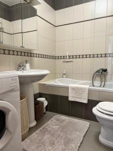 a bathroom with a sink and a toilet and a tub at Sea View Apartment in Matulji +21 photos