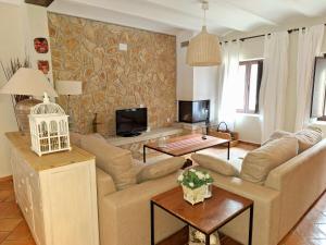 a living room with a couch and a table at El Pinar de la Lobera in La Matea