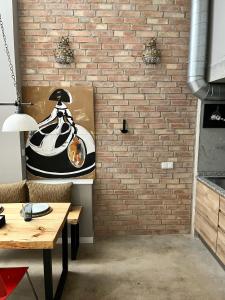 a brick wall with a table and a dining room at Loft Industrial 22 in Murcia