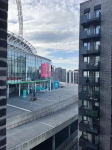a view of a building with a parking lot at Perfect flat next to Wembley Stadium in London