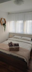 a bed with a basket on top of it at Apartman Klara in Osijek