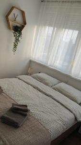 a bedroom with two beds and a window at Apartman Klara in Osijek