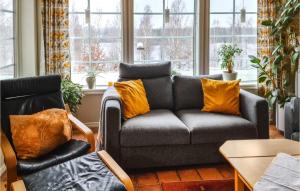 a living room with a couch and two chairs at Beautiful Home In Ryd With Sauna in Ryd