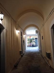 un couloir vide avec une arche dans un bâtiment dans l'établissement Pozzo Canale House, à Catane