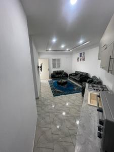 a large living room with a couch and a kitchen at DIaR MAHER in Al Maqārisah