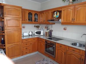 a kitchen with wooden cabinets and a sink at Berdullas in Vilagarcia de Arousa