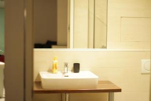 a bathroom with a white sink and a mirror at Home Sweet Home - Stephansdom II in Vienna