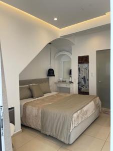 a bedroom with a large bed and a kitchen at Galatia Villas in Fira