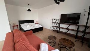 a living room with a couch and a bed at 2 room Apartment with terrace, new building, B1 in Bratislava