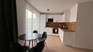 a kitchen with a table and chairs in a room at 2 room Apartment with terrace, new building, B1 in Bratislava