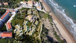 an aerial view of a resort near the beach at Aspro Krino Dunes - Adults only in Vasilikos