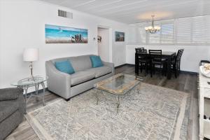 a living room with a couch and a table at Sea Palm 1D condo in Fort Walton Beach