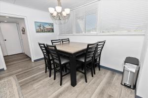 a dining room with a table and black chairs at Sea Palm 1D condo in Fort Walton Beach