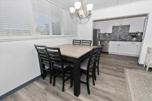 a kitchen and dining room with a wooden table and chairs at Sea Palm 1D condo in Fort Walton Beach