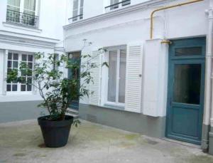 una planta en una maceta frente a un edificio en Appartement Design Champ de Mars, 2 piéces Quartier Tour Eiffel, en París