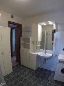 a bathroom with a sink and a mirror at Appartamento con terrazza e giardino in Val d'Intelvi in Lanzo dʼIntelvi