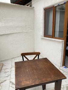 a wooden table and a chair in front of a window at Ulusoy Old Cıty in Istanbul