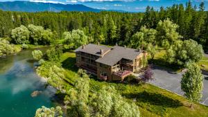 an aerial view of a house next to a river at Duck Inn Lodge in Whitefish