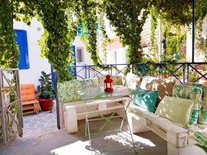 a patio with a couch and a table and chairs at Archipelagos Kimolos in Kimolos