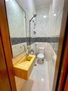 a bathroom with a sink and a toilet at MASA HOTEL APARTMENT in Mansoura