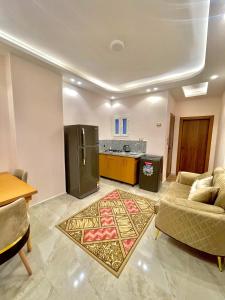 a living room with a couch and a kitchen at MASA HOTEL APARTMENT in Mansoura