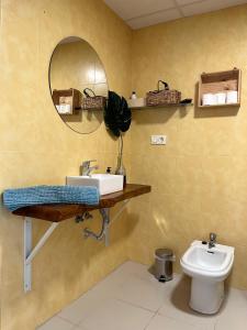 y baño con lavabo, espejo y aseo. en Apartamento San Juan 3, en Murcia
