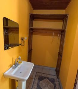 a bathroom with a sink and a mirror at Playa San Diego Beachfront Rentals in Managua