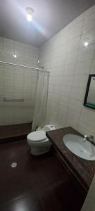 a bathroom with a toilet and a sink at LA COLINA Casa-Hospedaje in Máncora +76 photos
