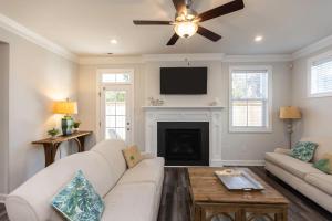a living room with a white couch and a fireplace at Three Minute walk to the Beach in Virginia Beach