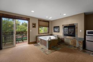 a large bathroom with a tub and a balcony at Duck Inn Lodge in Whitefish