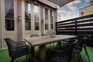 a wooden table and chairs on a patio at The Alexandre in New Orleans