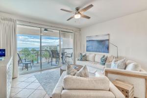 a living room with a couch and a ceiling fan at Hp 422 Blue Haven in Rosemary Beach