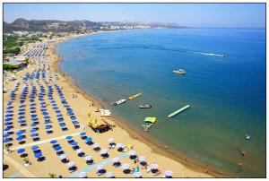 an aerial view of a beach with umbrellas and people at RHODIAN TREASURE Spiridione studio 1 in Faliraki