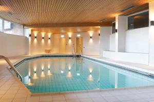 a pool in a building with a swimming pool at Waldruhe Apartments Bad Essen in Bad Essen