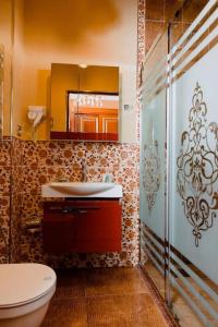 a bathroom with a toilet and a sink and a mirror at Royal Historical Boutique Hotel in Baku