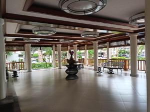 a large room with a porch with benches and windows at Syv's 2Br & 1T/Bath Condo Oasis Behind SM Mall 411 in Davao City