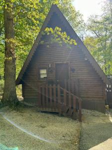 a log cabin with a wooden fence in front of it at A-Frame Cabin #5 with Hot Tub on Patoka Lake in Southern Indiana in Paoli