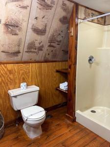 a bathroom with a white toilet and a shower at A-Frame Cabin #5 with Hot Tub on Patoka Lake in Southern Indiana in Paoli