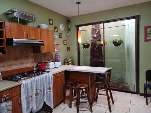a kitchen with a stove and a counter top at Habitación el mirador in San Rafael