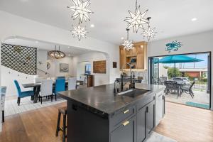 an open kitchen and dining room with a table and chairs at Spanish Villa with View Pool and Spa in San Diego