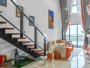 a living room with a staircase in a house at Jacuzzi,Loft,Highest Floor,SG city View,10min to CIQ in Johor Bahru