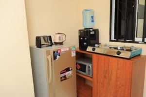 a kitchen with a refrigerator and a microwave at The Modern loft in Nairobi